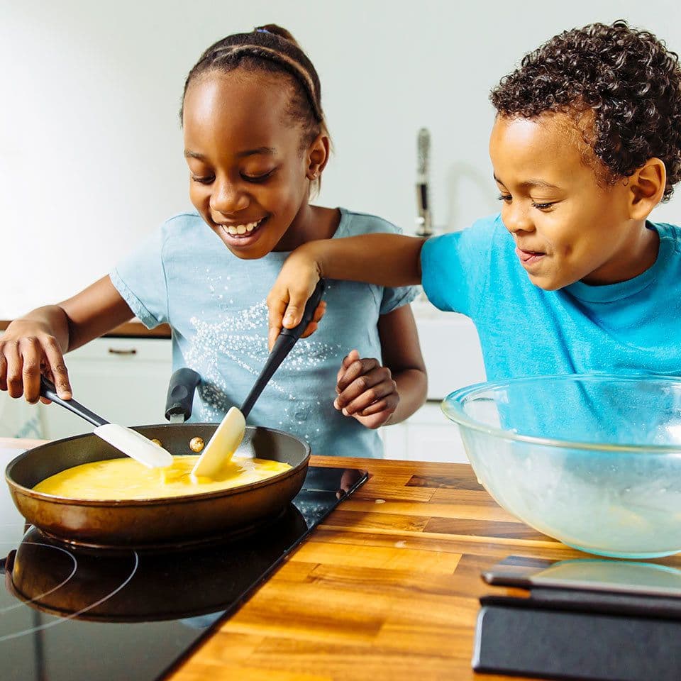Children learning to cook in a culinary class